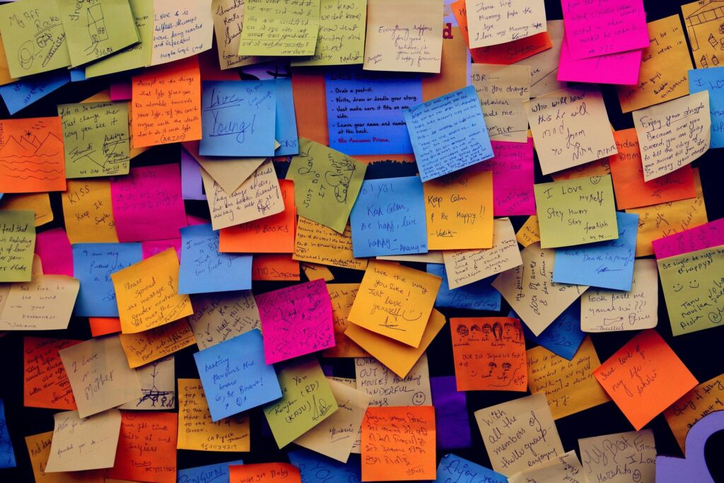 A haphazard collection of post-it notes on a wall