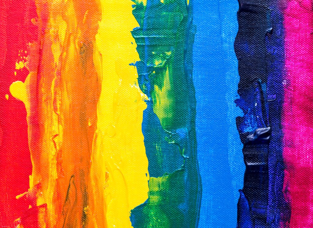 Vertical stripes of rainbow colors with noticeable paint streaks on canvas